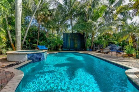 The rain wall at the edge of the pool creates the perfect soundtrack to your relaxing vacation under our swaying shady palms in Fort Lauderdale.