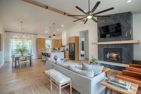 The open concept floor plan includes a great room, dining room and kitchen in the main common area. The primary bedroom is split from the second and third bedrooms, with the common area between them.