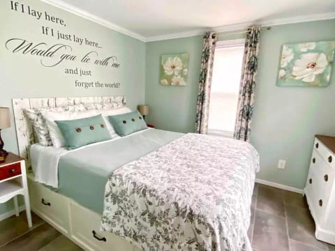 Queen size memory foam bed (medium firmness) on a Pottery Barn storage frame along with a dresser and standing armoire for clothing.
