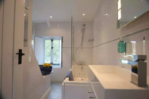 Upstairs bathroom with spa bath and contemporary style