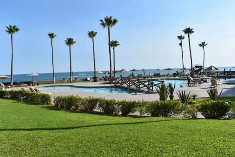 Patio view of resort pool and ocean