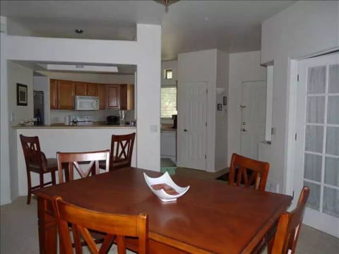 From the dining area looking back at the kitchen and entrance