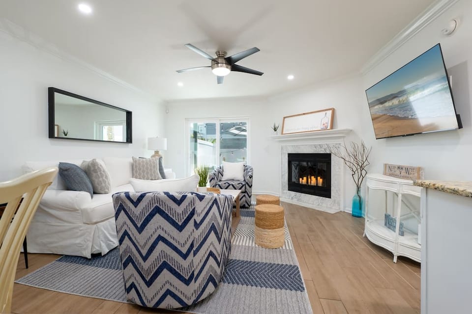 Comfortable and cozy Living area on ground level leads out to fenced in yard with patio furniture and games