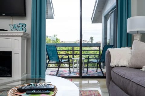 Cozy balcony faces east toward the ocean & the perfect spot for morning coffee