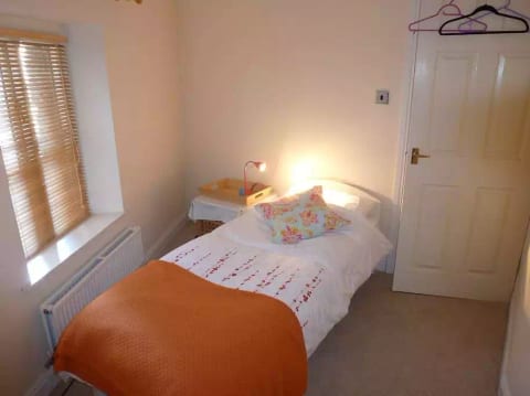 This quirkily shaped room has a narrow but full length single bed.