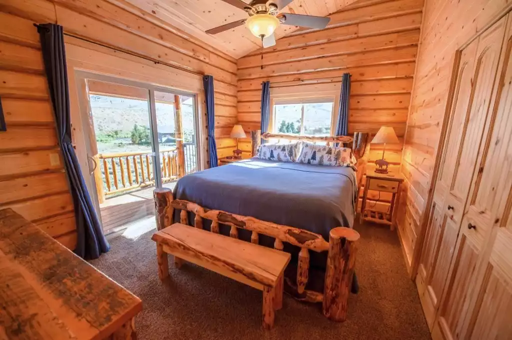 Bedroom #2 - Main floor Cal-King bed with deck facing the river. - The Caddis Shack - West Yellowstone