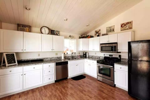 Fully stocked updated kitchen upstairs with sliding doors to the wrap around deck with a lake view