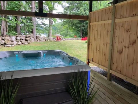 Private outdoor hot tub under cover.