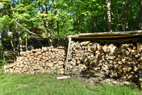 Still more firewood stacked on our front lawn.