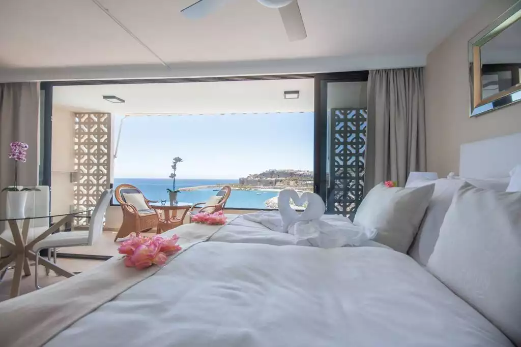 The king-size bed is firm with high-quality linens and two layers of toppers. Choose either a large duvet or two individual ones, just let us know your preference when you book - Oceanfront Escape with Elegance & Panoramic Views - Patalavaca