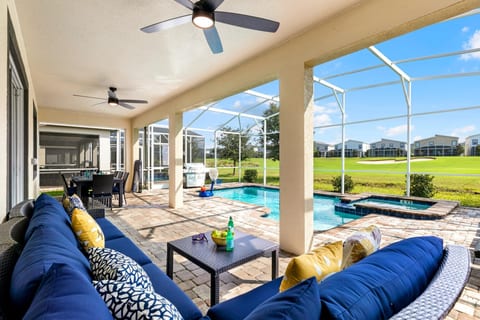 Your view sitting on the comfy outdoor sectional facing the salt water pool and spa and the golf course