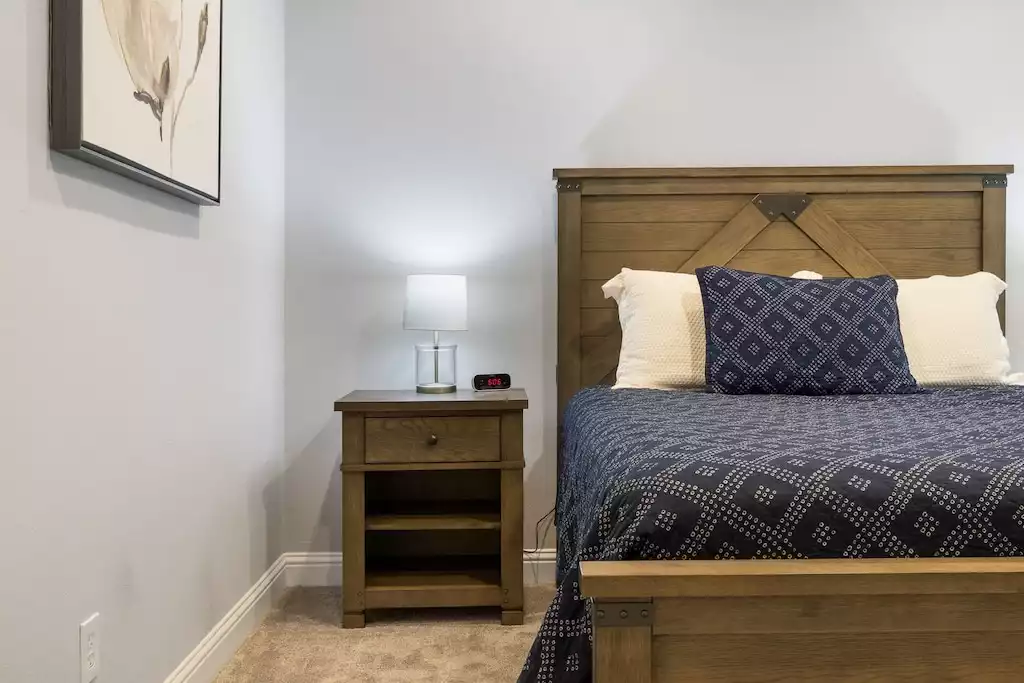 Bedroom #6 with queen bed, walk-in closet and views of the pool. - Main House at Whispering Oaks Estate - Dripping Springs