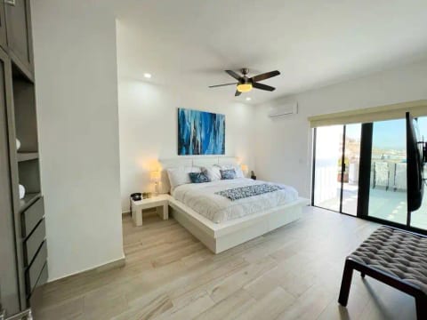 Main bedroom with king bed, super soft imported sheets, a 55-inch flatscreen, Sonos surround sound & an accompanied Sonos speaker next to the bed. Large closet, attached bathroom w/ dual sinks, rain shower, access to expansive deck, BBQ and laundry.