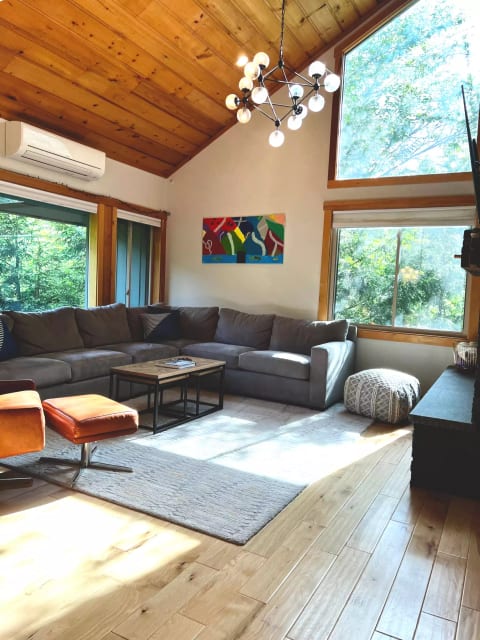 Beautiful, sunny open-concept family room/ kitchen with plenty of views & seating all centered around a beautiful fireplace (and smart TV).
