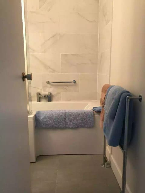 L-shaped shower bath. Full size deep bath. Big bath towels!