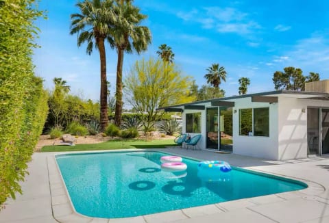 Large rectangular pool and garden area for games. Multiple seating areas for everyone to spread out and enjoy the desert sun.