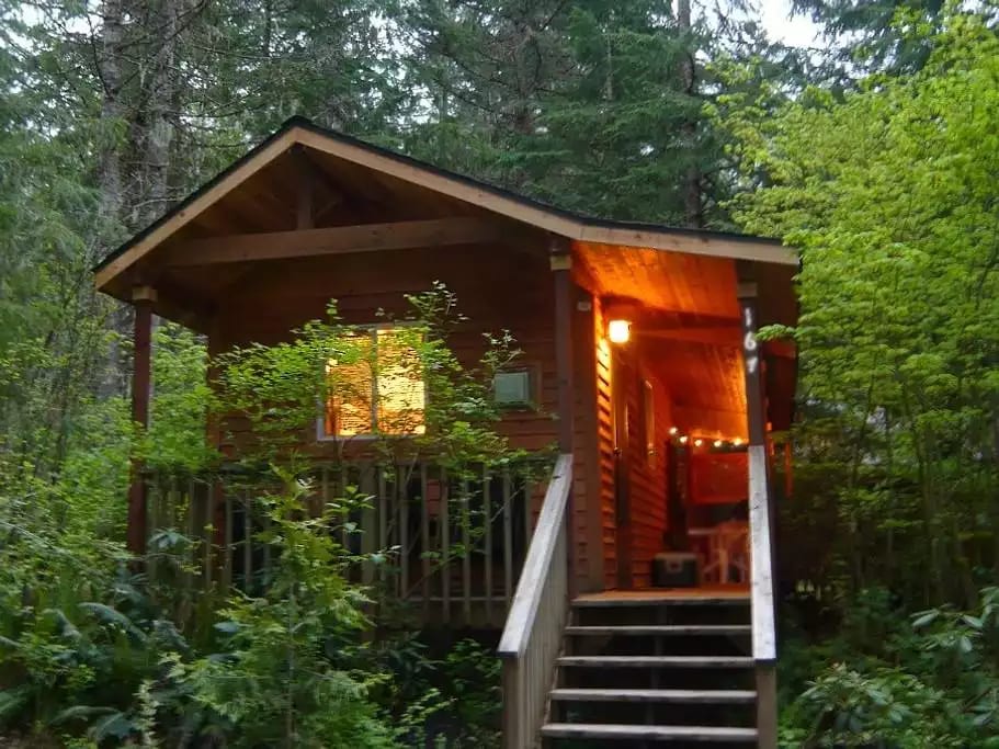 Our "tiny cabin" with BIG mountain charm. The hot tub is on the back deck as well as the outdoor grill.