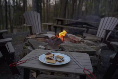 Beautiful fire pit and comfortable Adirondack chairs. Additional chairs are available on the property. Includes grill top, skewers, fire wood and starter logs.