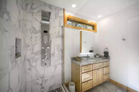 Cypress ensuite bathroom with rainfall spa shower system