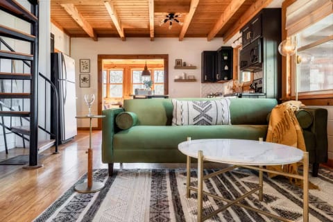 Open, airy and cozy living room with spiral staircase to access the upper level.