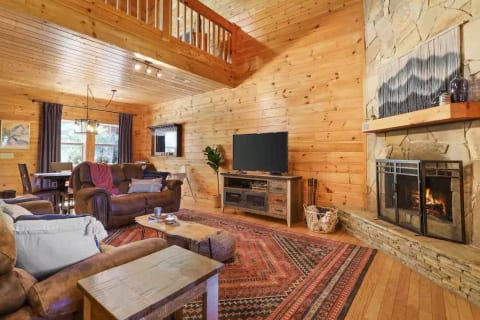 The cozy living room- perfect spot to unwind by the fireplace with a book, or log into your streaming accounts on the roku TV.