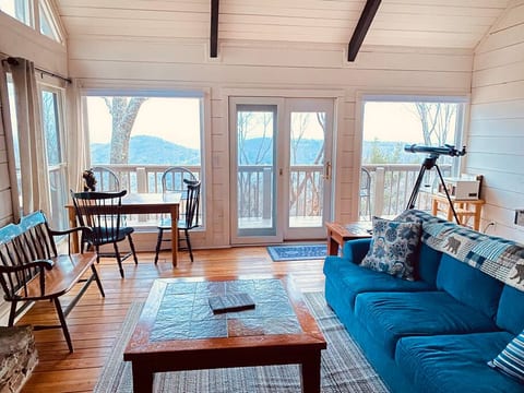 Living room (main level) - TV, shuffleboard table, sectional with pull-out queen bed, puzzle/game table