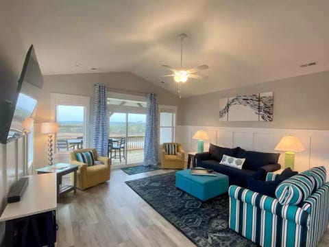 The "Great Room" features expansive views of Waters Bay and the ICW, all new comfortable furniture, a 65" smart TV, and opens to a large deck to take in an even wider view of the Bay and the ocean.