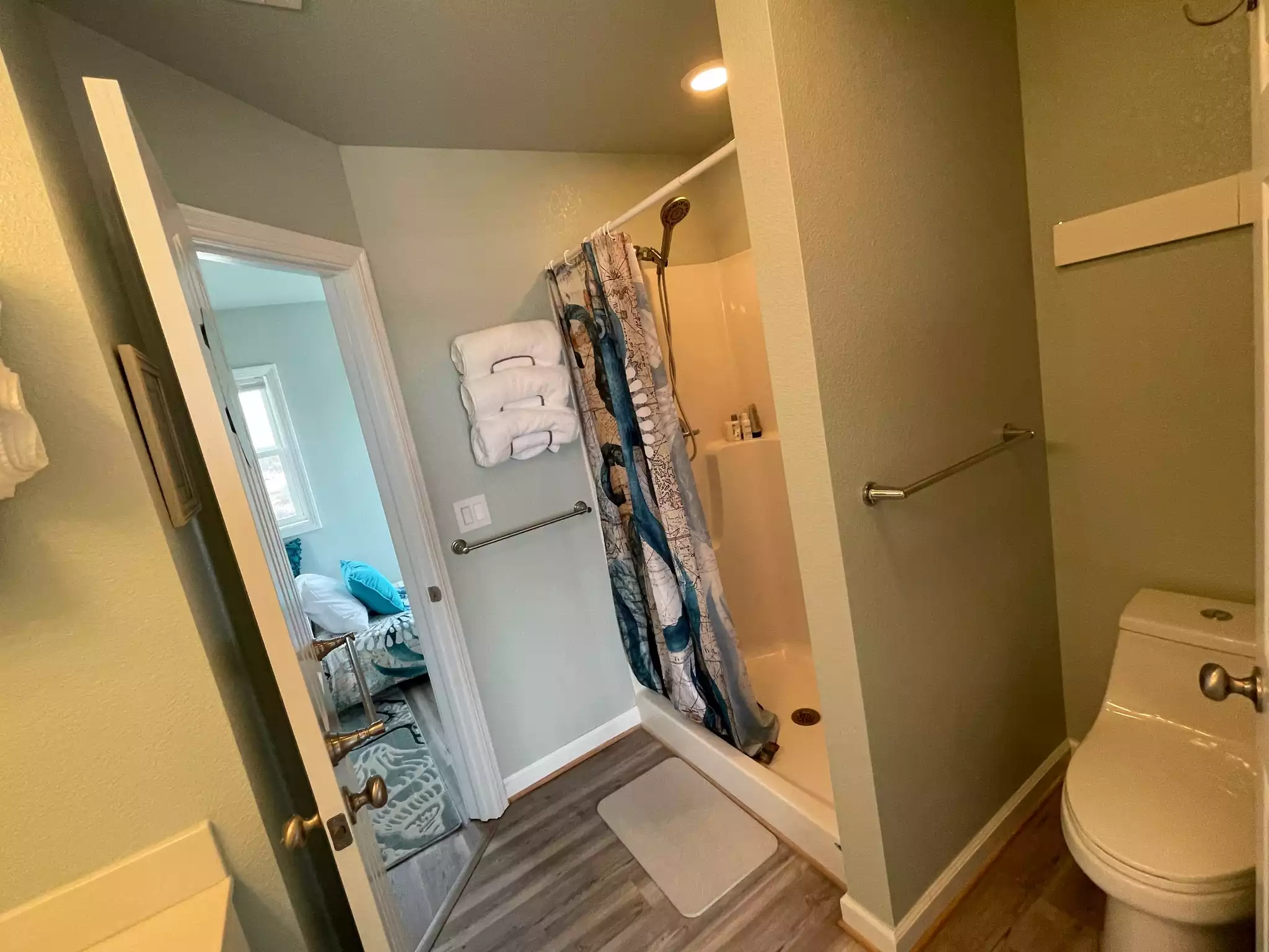 Fold out drying rack over toilet tank. Note the third towel bar on the door into Twin Dune. Since this bath could be used by up to five people, we tried to include as many towel hanging spots as we could.