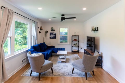 This is the main living room for our AirBnB! The 55" smart-TV is complimented by the cozy sectional, stylish chairs and lots of natural light!