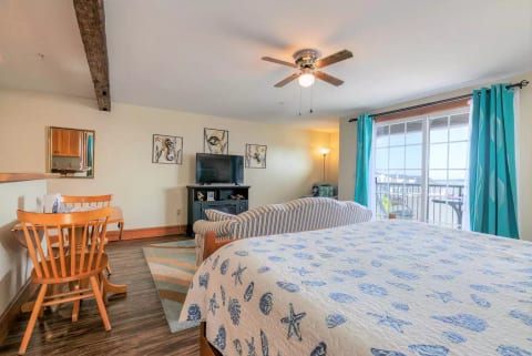 Living room area - Smart TV and electric fireplace, sliders to balcony with beach view