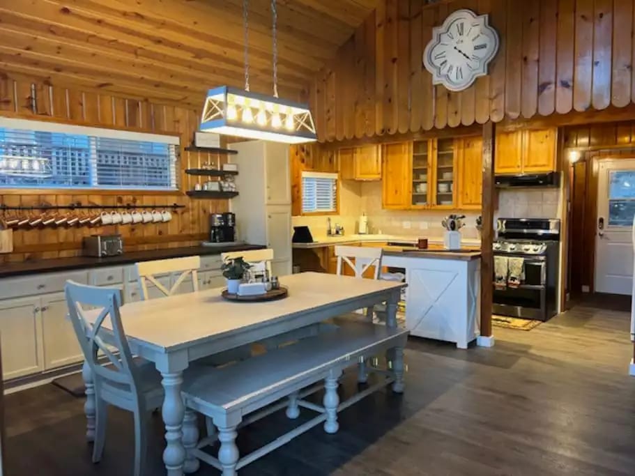 Dining Room: features large FarmStyle dining table, four chairs and one bench. Included in the dining room is a bar area featuring Copper Mugs, Bar Mixing Equipment Supplies, A Keurig, with coffee pods, and sweetener; just bring the creamer!