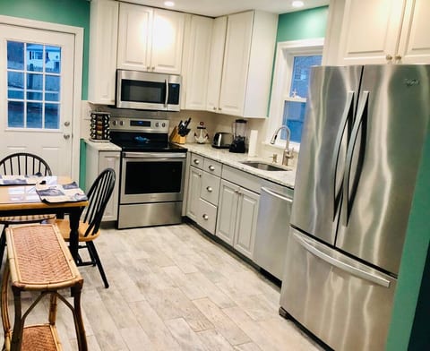 NEW kitchen withttps://app.guesty.com/reservationsh quartz counter tops, stainless steel appliances and beach-wood style tile floors.