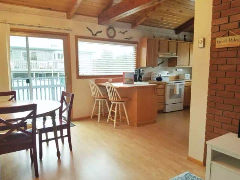 Drop-leaf table with 4 chairs, a high chair, and additional chairs in upstairs bedroom closet