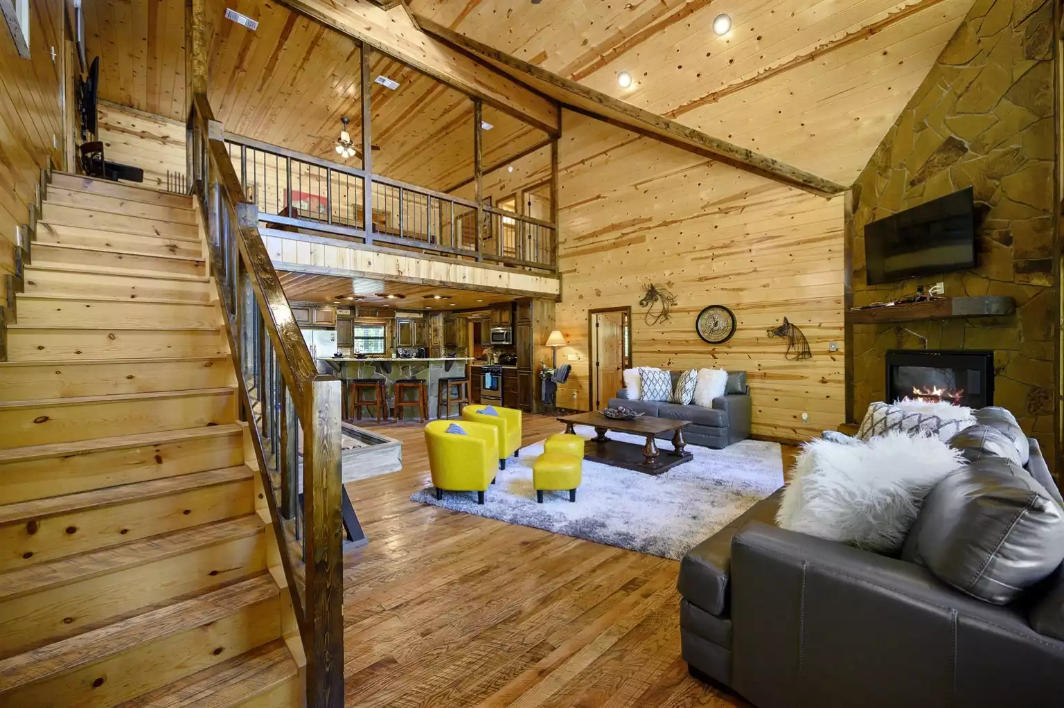 Living Room with stairs to upper level Living Room with stairs to upper level - Iron Horse Lodge - Broken Bow