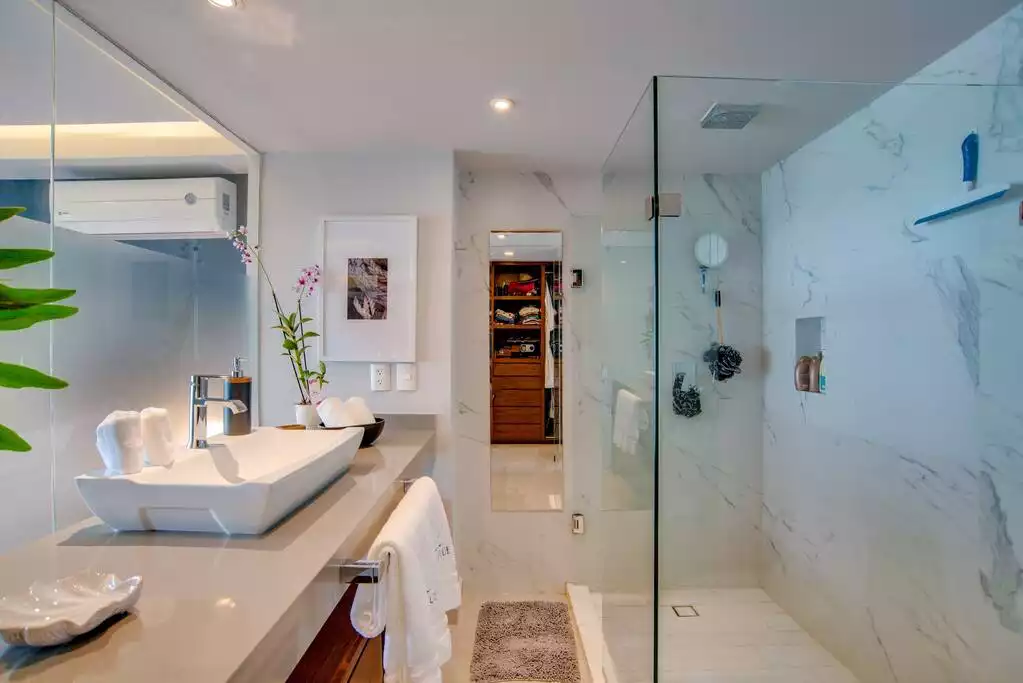 The master bath has a large vanity with large basin and a rain shower.