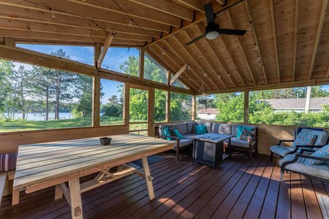 Screen porch with fire table and string lights