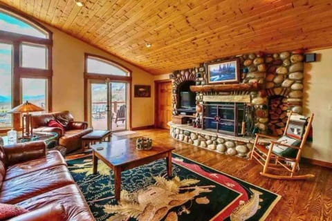 Main living space with wood burning fireplace and gas starter.